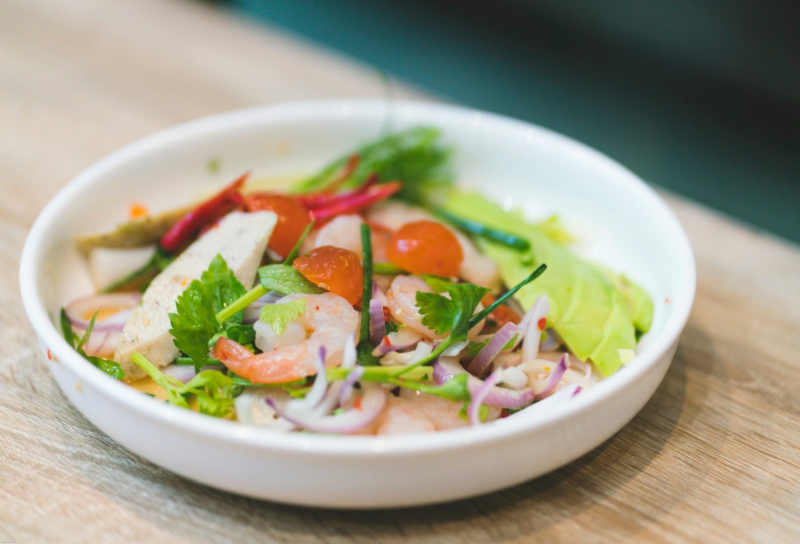 Thai-style salad presented in a white bowl